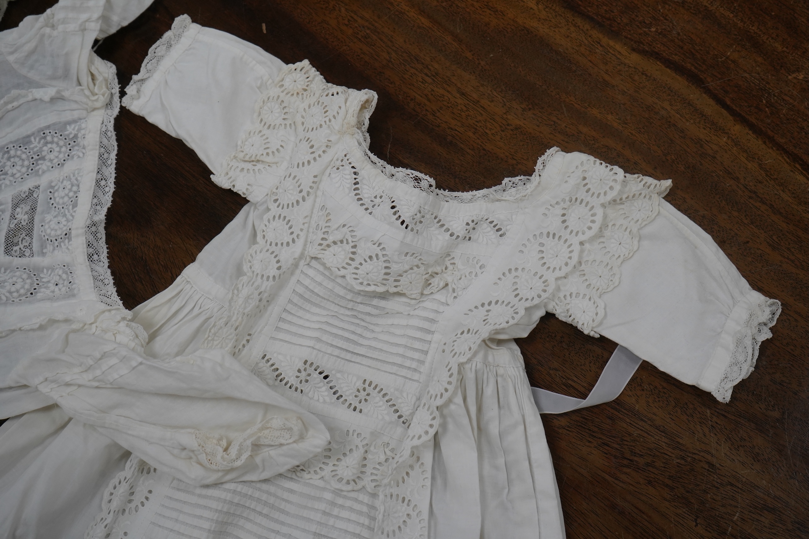 Five Victorian white worked fine cotton and lawn baby’s christening gowns. mostly worked with embroidery anglaise, feather stitching, tucking, drawn thread work and lace edging, longest 41cm. Condition - in good conditio